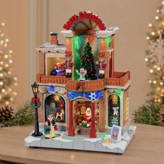 Casa Natalizia Animata con Led, Musica e Movimento Timstor 21×15×29 cm.