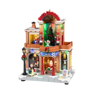 Casa Natalizia Animata con Led, Musica e Movimento Timstor 21×15×29 cm.