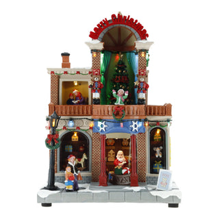 Casa Natalizia Animata con Led, Musica e Movimento Timstor 21×15×29 cm.